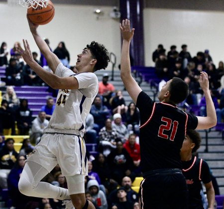 Lemoore's Micah Fox drives for the basket against Hanford.